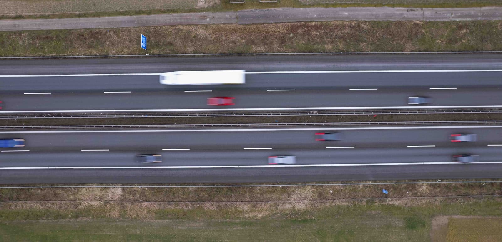 Aerial view of a highway with cars in motion