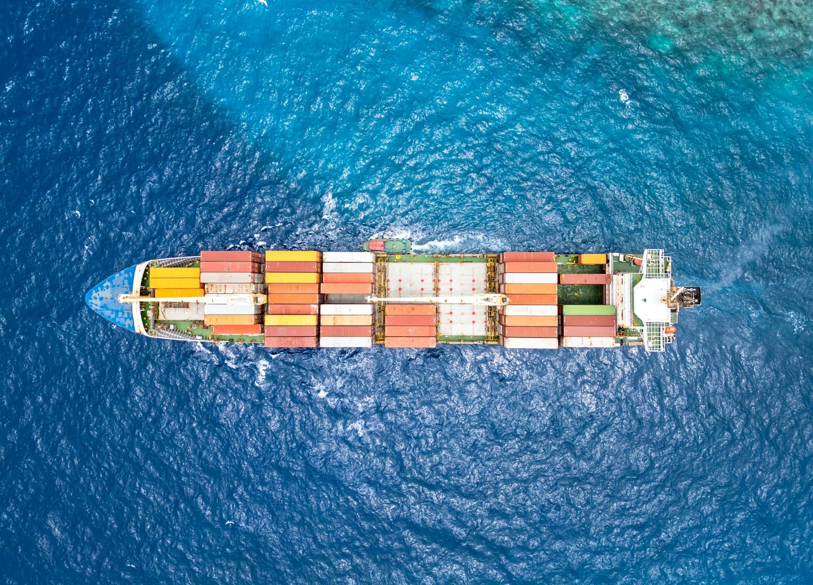 Aerial view of a container ship crossing open ocean